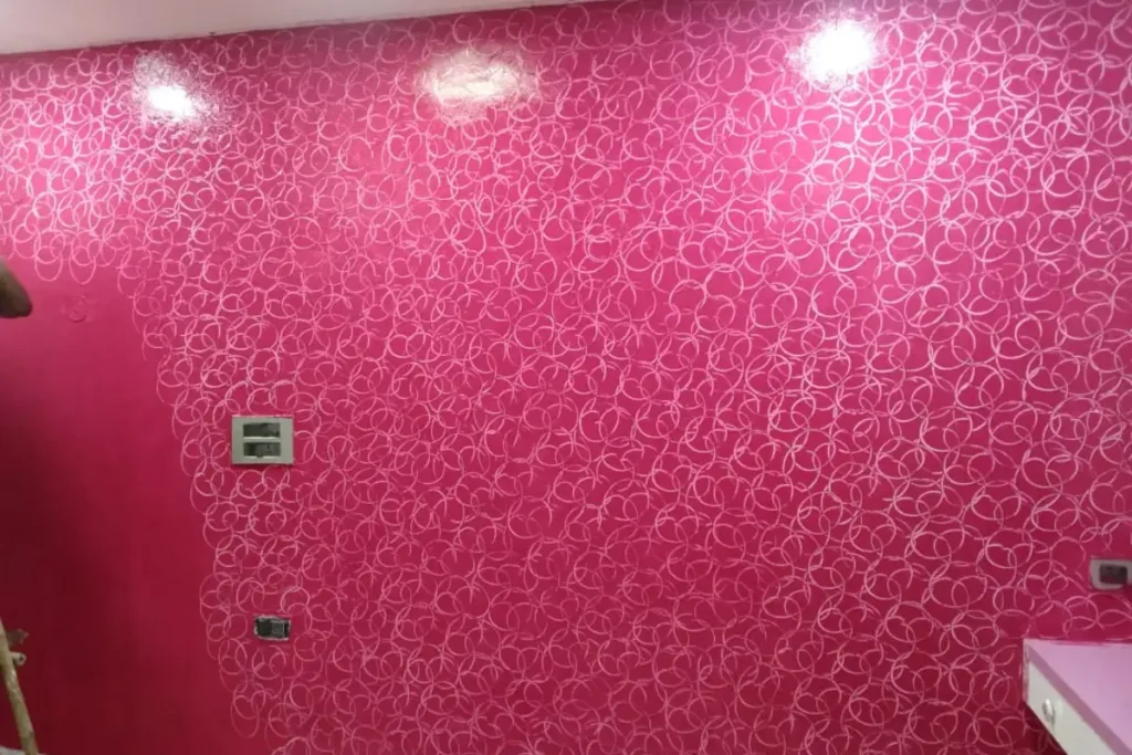 Pink decorative textured wall paint with abstract circular pattern design