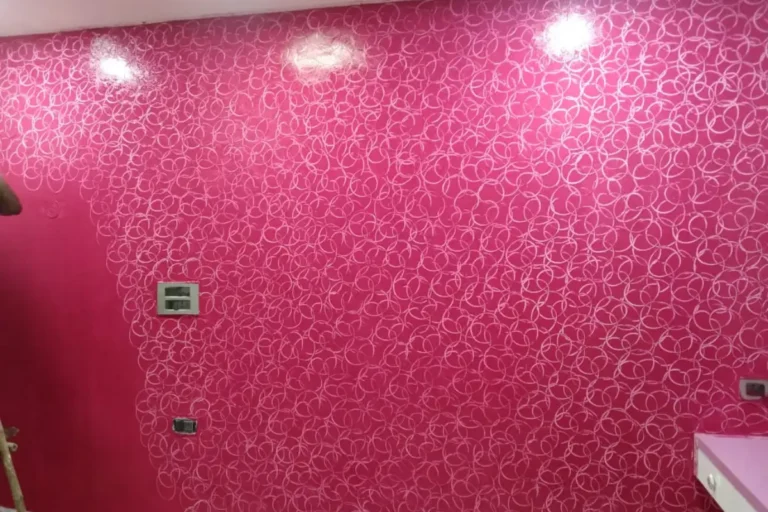 Pink decorative textured wall paint with abstract circular pattern design